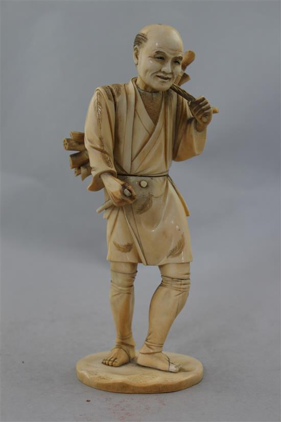 A Japanese sectional ivory figure of a farmer, 21.5cm